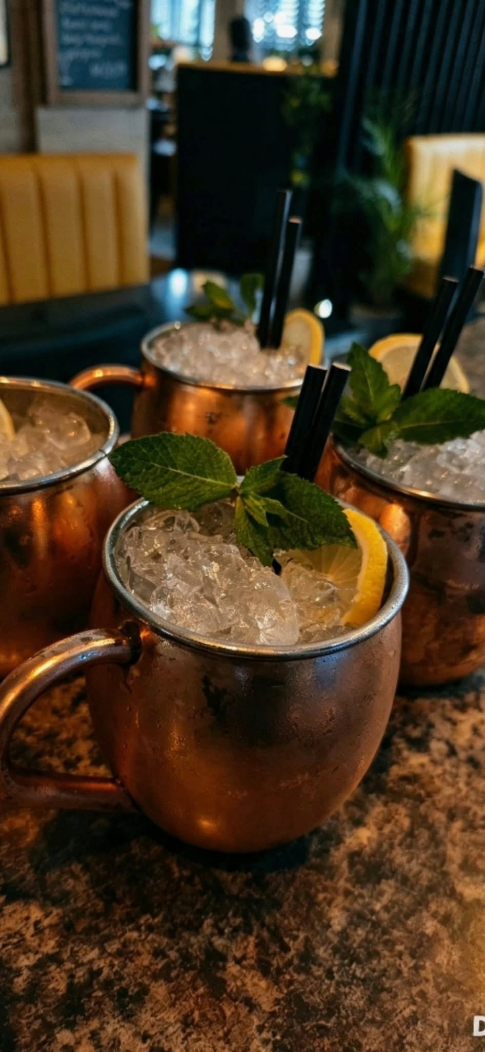 Cocktails in copper mugs with ice, lemon and mint