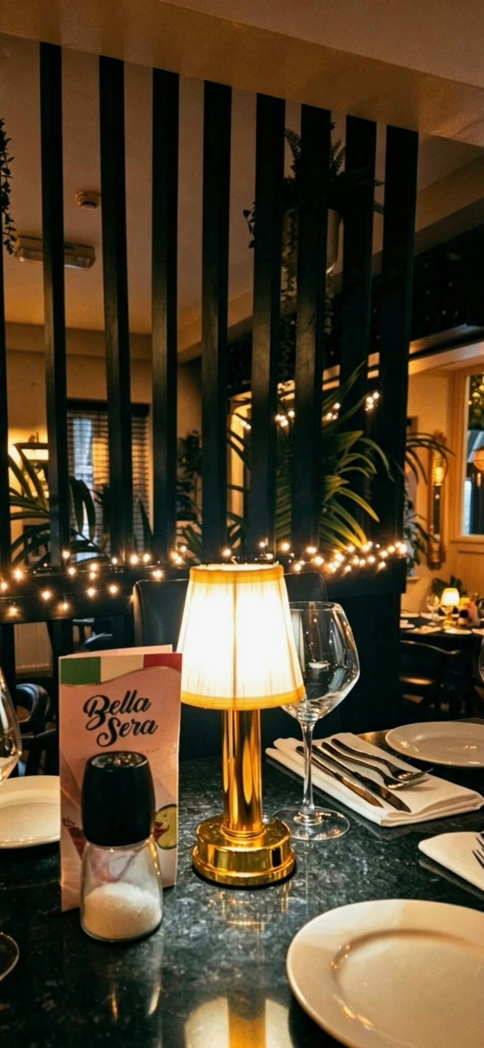 Wine glasses and a table lamp in Bella Sera’s dining room