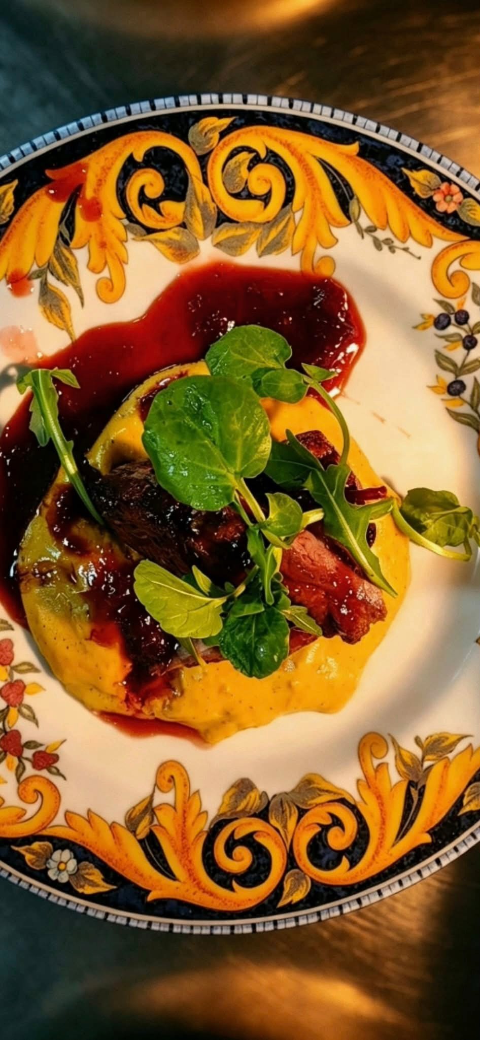 A main course with sauce and fresh green garnish