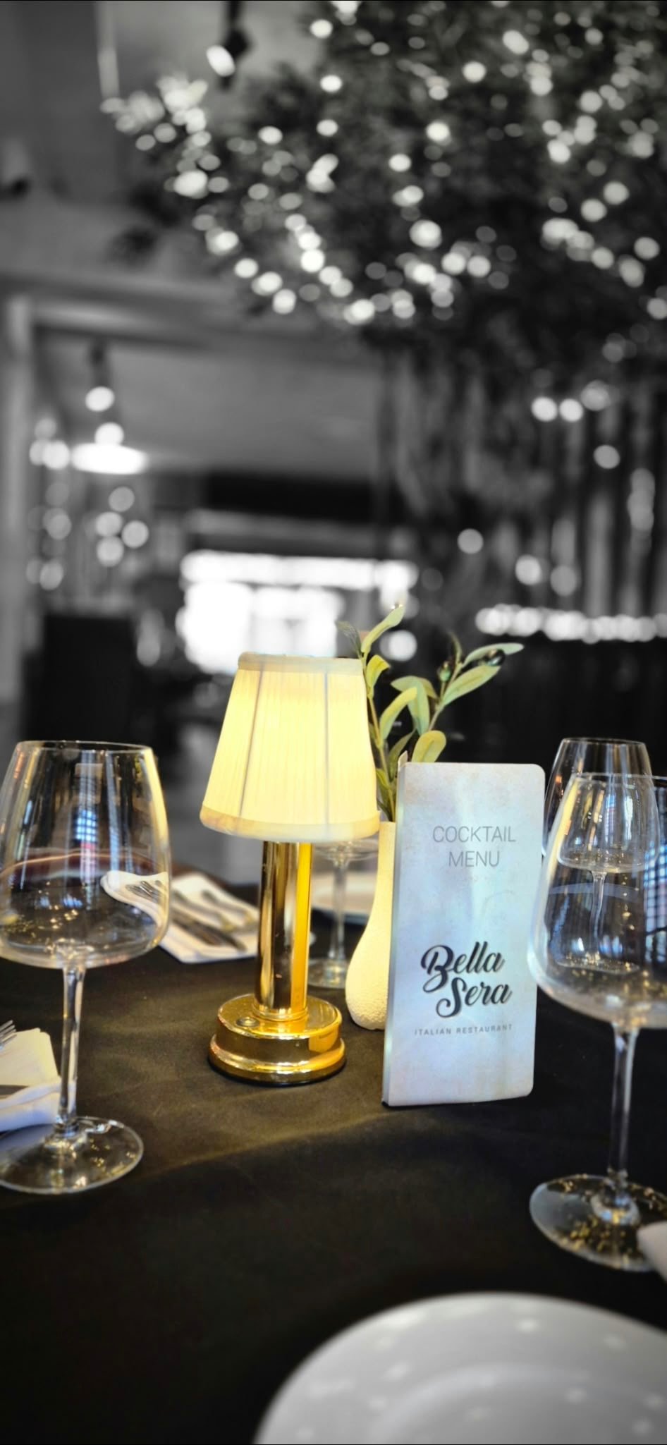 A softly lit table set for dinner at Bella Sera